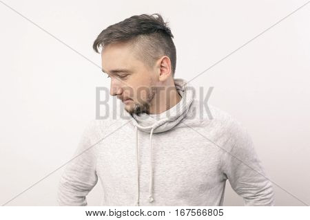 Young Man Looks Down Guiltily. Depression And A Sense Of Loneliness