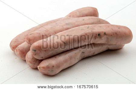 A stack of six raw chipolata sausages ready for cooking