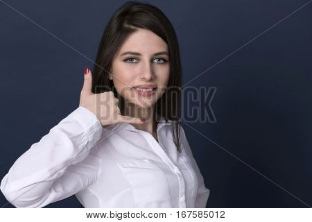 Call me a pretty young brunette woman, isolated on blue backgroundd