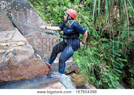 Beaufort,Sabah,Malaysia-Jan 28,2017: A adventurer canyoneer get ready to abseil down a waterfall in Beaufort,Sabah,Borneo.Waterfall Abseiling activity adventure getting famous in Sabah,Malaysia.