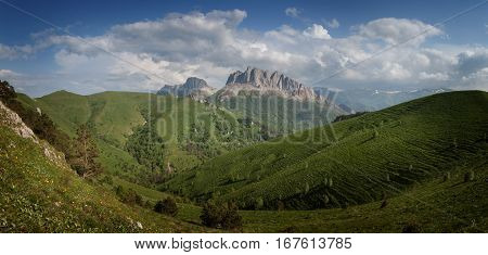 Caucasus mountains (Eastern and Western Acheshbok) under a blue sky with clouds. Caucasus Russia