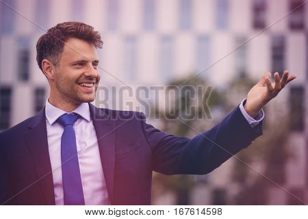 Close up of handsome businessman gesturing outdoors