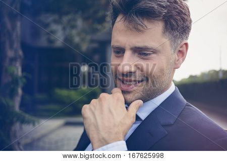 Close up of thoughtful businessman smiling outdoors