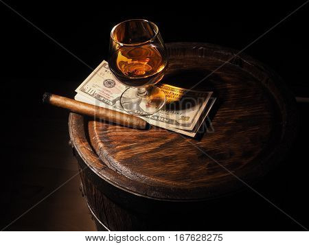 Cognac ,cigar And Dollars On Old Oak Barrel