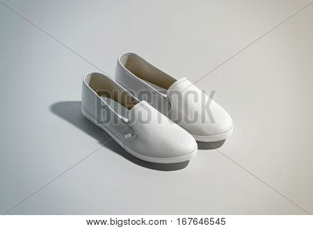 Blank white slip-on shoes pair design mockup isometric view 3d rendering. Plain hipster slipon mock up template stand. Urban skate shoes with clear label presentation.