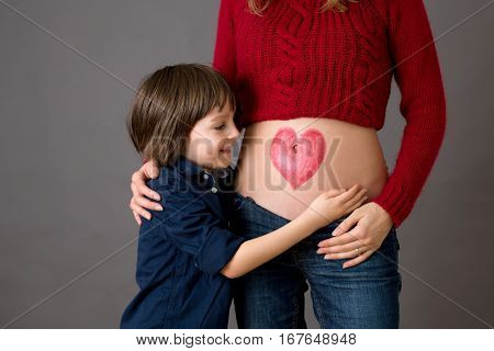 Beautiful Preschool Child, Hugging His Pregnant Mom