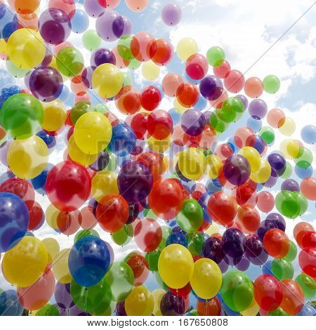 balloons and celebration concept - lots of colorful balloons in the sky