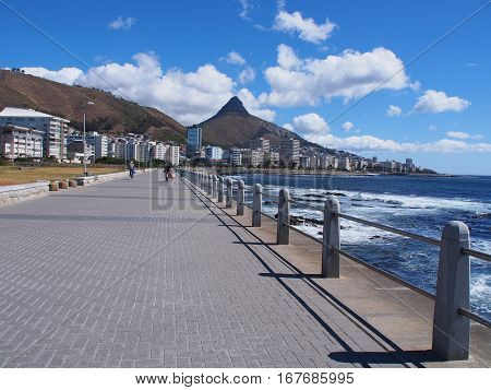 Pathway beside the sea in Cape Town, South Africa. Lion's Head mountain on the background.