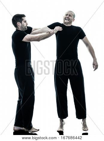 two caucasian men krav maga fighters fighting isolated silhouette on white background