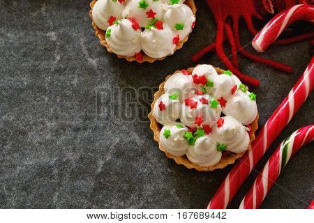 Holiday Christmas tartlets with meringue and decorated with caramel almonds