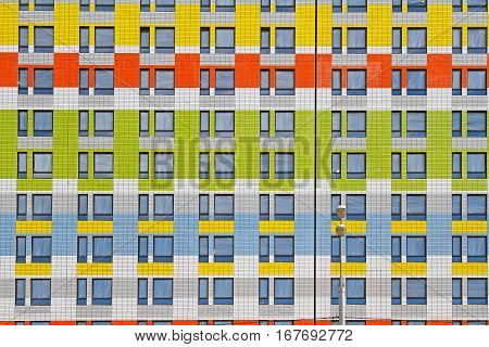 Colorful facade of a modern building with street lantern