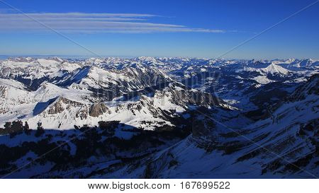 Winter morning in the Bernese Oberland. View from the Glacier des Diablerets summit station. Snow covered mountain ranges of the Swiss Alps.