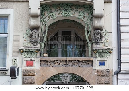 Several windows in a row and balcony on facade of urban apartment building front view, St. Petersburg, Russia