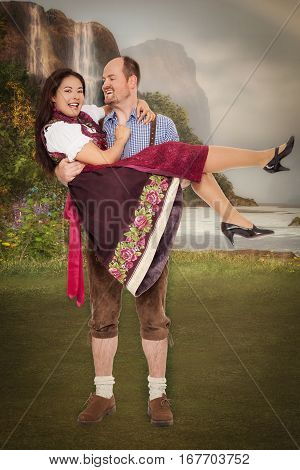 Bavarian man in leather pants wears his girlfriend in the Dirndl Dress on the poor.
