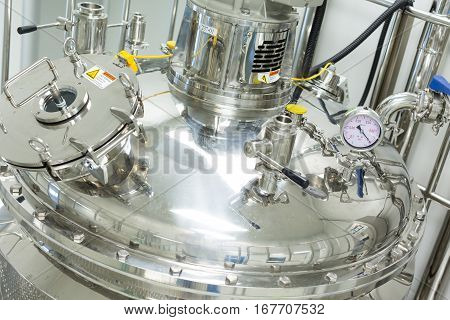 big chromed tank with pressure plate in pharmaciutical factory