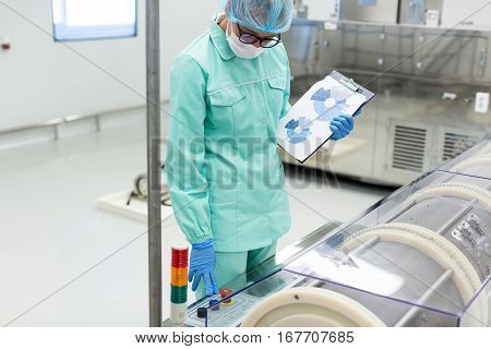 Science Worker Compares Readings Of Equipment