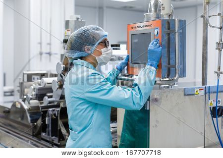 Factory Worker Configures Control Panel