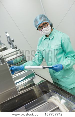 Scientist Is Making Notes Of Machine