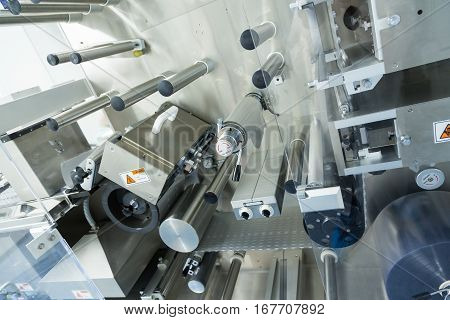 big manufacture machine with shafts in pharmaciutical factory