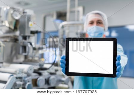 Scientist Near Steel Machine Hold Empty Tablet, Focus On Tablet, Blured Back