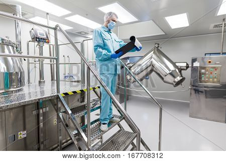 Plant Picture, Scientist Is Standing On Ladder In Laboratory, Checking Readings