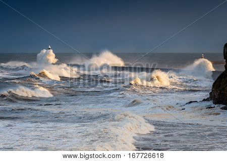 Surging Waves onto Tynemouth Pier, as a stormy sea hits it, resulting in high crashing waves cascading into the mouth of the River Tyne