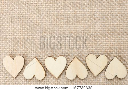 Wood hearts on hessian texture background valentine background