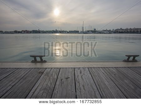 Idyllic sea view from a dock, sunset. Soft light pastel shades. Valencia port