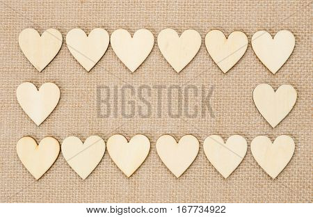 Wood hearts on hessian texture background valentine background