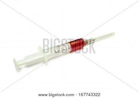 syringe with a red liquid isolated on white background