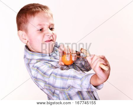Young Boy Use Sling Shot Shoot Mandarine.