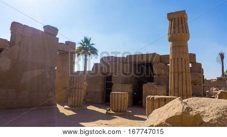 Ruins of an ancient temple of Egypt with statues and columns