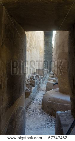 Ruins of an ancient temple of Egypt with statues and columns