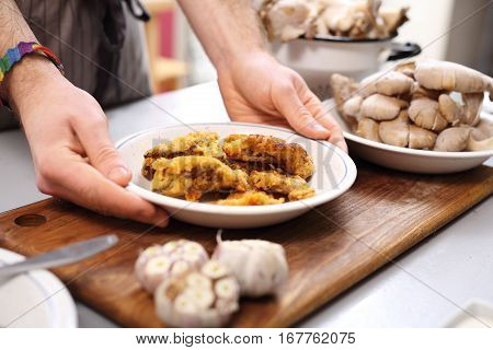Oyster mushrooms coated in breadcrumbs. Vegan dish.
Vegan dish. The cook prepares a dish dinner.