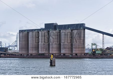 row of silos in the rotterdam bulk terminal the place for storage and transshipment of dry minerals including bauxite magnesite and bentonite.
