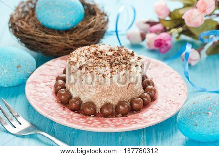Traditional orthodox Easter dessert with cottage cheese and chocolate. Chocolate curd paskha with chocolate candy on holiday Easter table