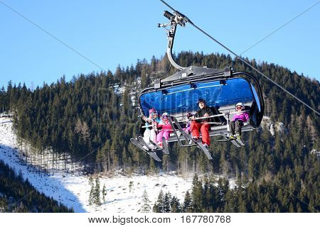 JASNA SLOVAKIA - JANUARY 22: The cabins of Lucky cableway with family of skiers in Jasna Low Tatras. It is the largest ski resort in Slovakia with 49 km of pistes on January 22 2017 in Jasna Slovakia