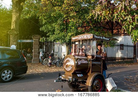 STRASBOURG FRANCE - NOV 1 2016: Monsieur Franchi hot chestnut maroons ambulant seller at the entrance of Orangerie Park in Central Strasbourg Alsace France