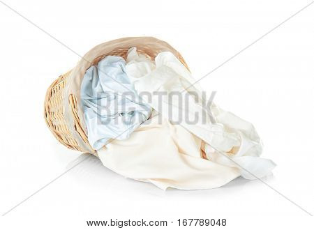 Clothes in wicker basket on white background