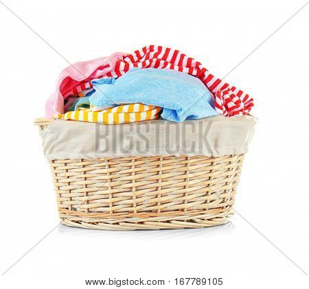 Clothes in wicker basket on white background