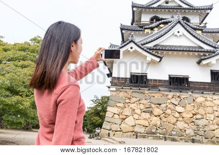 Woman taking photo on Hikone Castle