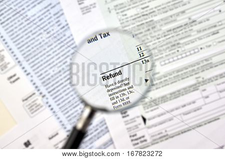 'Refund' under magnifying glass on 1040 U.S individual income tax return form