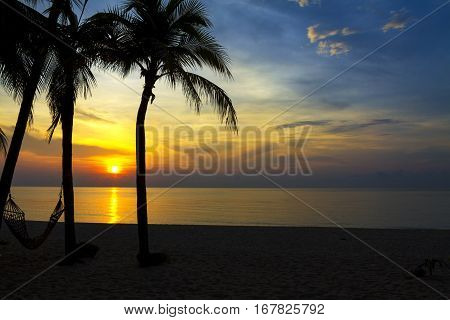 Sunrise and three coconut at Ban Krut Beach Prachuap Khirikhun Province Thailand