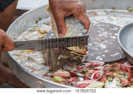 Preparing a fish fillet in Thailand market