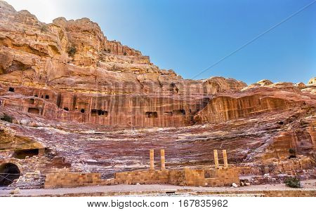 Red Carved Amphitheater Theatre Siq Petra Jordan. Theatre built in Treasury built by the Nabataens in 100 AD and the Romans added to it. The theater is produced from the red stone and seats up to 7000 people.