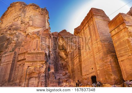 Yellow Rock Tombs Morning Street of Facades Petra Jordan. Built by the Nabataens in 200 BC to 400 AD. Yellow rock tombs become rose red in the aftrnoon when the sun goes down. Reds are created by magnesium in sandstone.