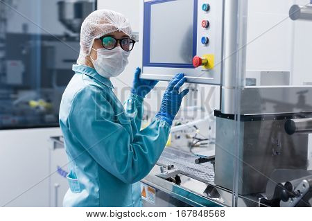 Factory Worker Configures Control Panel