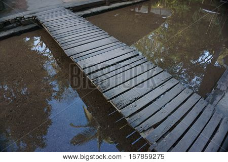 Old Wooden Bridge across over Waterin thailand