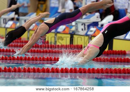 ST. PETERSBURG, RUSSIA - DECEMBER 17, 2016: Start of women 200 m breaststroke swimming competition during X Vladimir Salnikov Cup. Athletes from 6 countries participated in the competitions