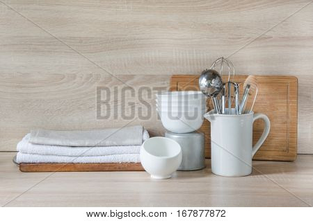Crockery tableware utensils and other different stuff on wooden table-top. Kitchen still life as background for design. Image with copy space.